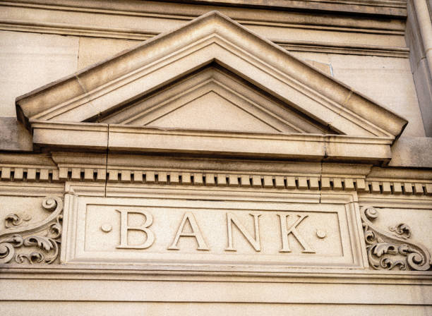 An old fashioned sign in carved stone, formerly over the entrance of a retail bank.