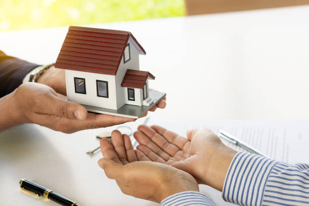 Real estate ideas, selling a house, or renting out real estate. The sales representative discusses the terms of the home sales contract for the customer to sign the legal contract document,